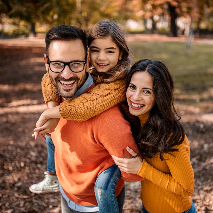 smiling young family in park